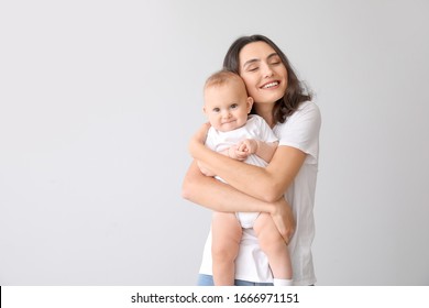 Cute Baby With Mother On Light Background