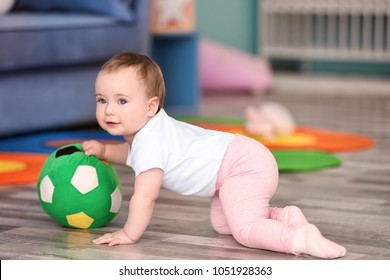 Cute Baby Playing With Ball At Home