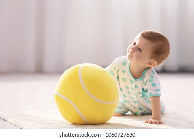 Cute Baby Playing With Ball At Home