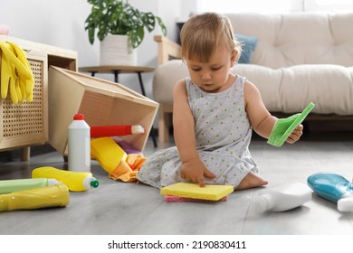 Cute Baby Playing With Cleaning Supplies On Floor At Home. Dangerous Situation