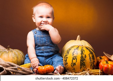 Cute Baby Posing On The Background Of Pumpkins. Thanksgiving Greetings