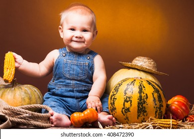 Cute Baby Posing On The Background Of Pumpkins. Thanksgiving Greetings