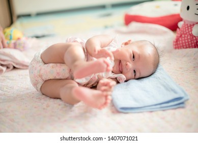 Cute Baby rolling time with smile. Action infant baby model rolling move on bed. in love moment with Baby for Children new born concept.