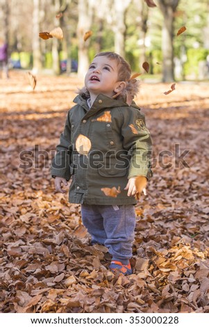 Image, Stock Photo Cute baby seeing falling leaves