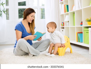 Cute baby sitting on bedpan and listening kid story with mom