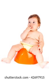 Cute Baby Sitting On The Orange Potty