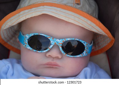 Cute Baby In Sunhat And Sunglasses