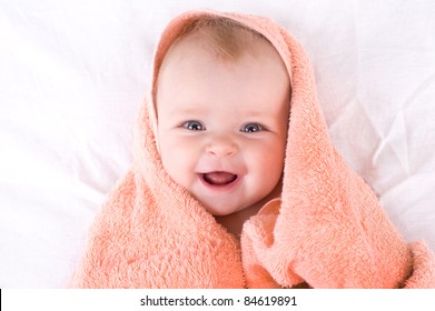 A Cute Baby Wrapped In A Towel.