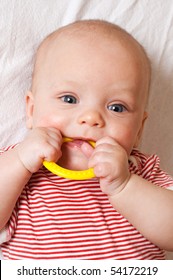 Cute Baby With A Yellow Teething Ring