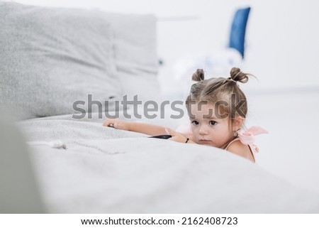 Similar – Little girl smiling lying over the bed