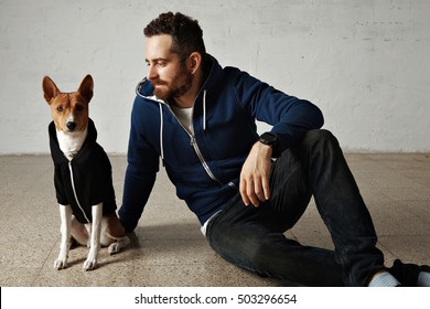 A Cute Basenji Dog And Its Owner Wearing Matching Outfits Sitting On The Floor