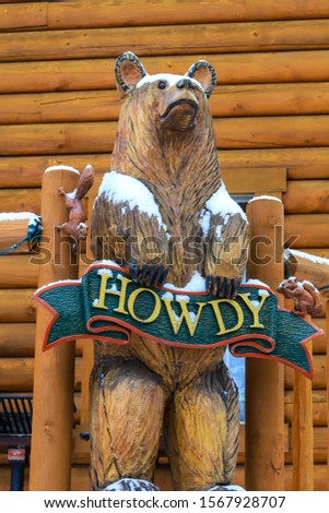 Cute bear welcoming wood carving with howdy sign