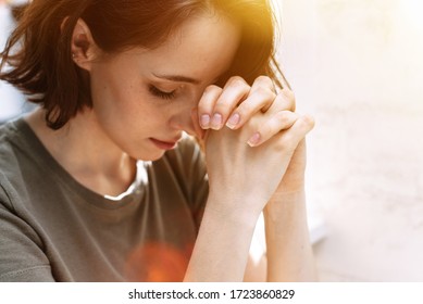 Cute beautiful girl folded her hands in prayer. A woman asks God for help - Shutterstock ID 1723860829