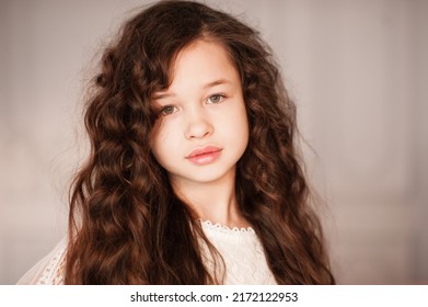 Cute Beautiful Kid Girl 10-12 Year Old With Long Dark Blonde Hair In Room Close Up. Portrait Of Young Teenager. Childhood. 