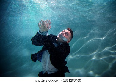 Cute Beginner Young Businessman With His Mouth Taped и And Hands Tied Underwater. Drowning Competitors In Pond. Concept Successful Business And Achieving Your Goal Among Competitors. Copy Space