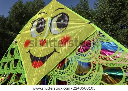 Cute and Big kite with amiley emoji flying. Foldable kite made of kite like material jumbo size