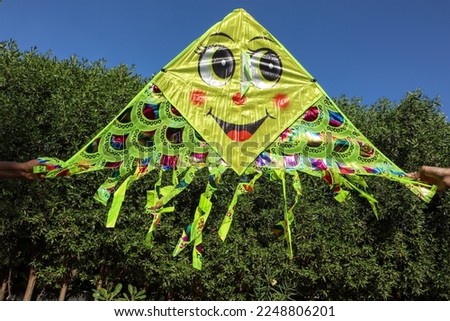 Cute and Big kite with amiley emoji flying. Foldable kite made of kite like material jumbo size