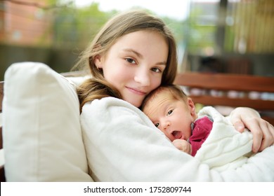 Cute Big Sister Admiring Her Newborn Brother. Adorable Teenage Girl Holding Her New Baby Boy Brother. Kids With Large Age Gap. Big Age Difference Between Siblings. Big Family.