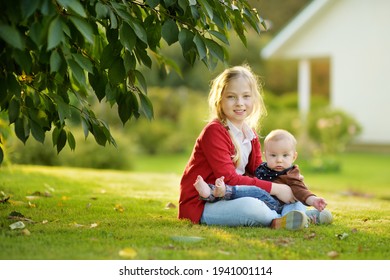 Cute Big Sister Cuddling With Her Baby Brother. Adorable Teenage Girl Holding Her New Baby Boy Brother. Kids With Large Age Gap. Big Age Difference Between Siblings. Big Family.