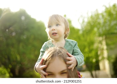 Cute Big Sister Cuddling With Her Toddler Brother. Adorable Teenage Girl Holding Baby Boy. Children With Large Age Gap. Big Age Difference Between Siblings. Big Family.