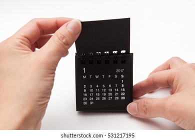 Cute Black Calendar Of 2017, New Year, Hand Turn Over Page Of 2016 On White Backgrounds