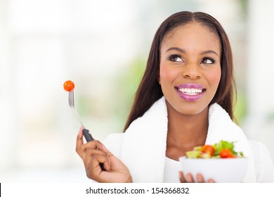 Cute Black Woman Eating Vegetable Salad At Home