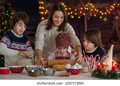 Cute blond child and his brothers and mom, baking christmas cookies at home, having fun - Shutterstock ID 2207172005