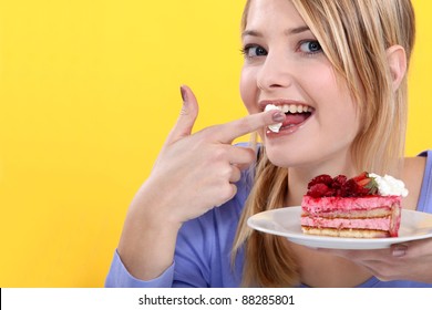 A Cute Blond Eating A Cake.