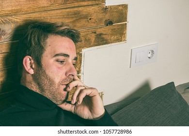 Cute blond guy with thoughtful expression and hand on face