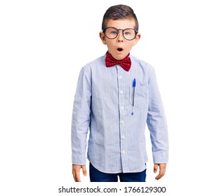 Cute Blond Kid Wearing Nerd Bow Tie And Glasses Scared And Amazed With Open Mouth For Surprise, Disbelief Face 