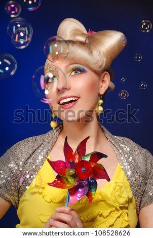 Cute blonde doll style model on the blue background