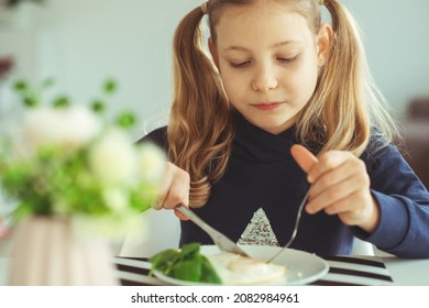 Cute Blonde Teen Girl Eating Eggs Benedict With Knife And Fork