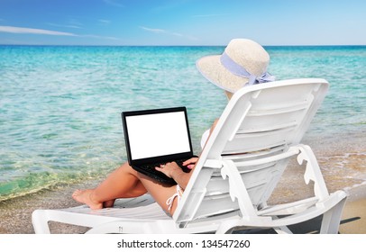 Cute Blonde Woman With Black Laptop And Hat In Lounge On Summer Sea Beach