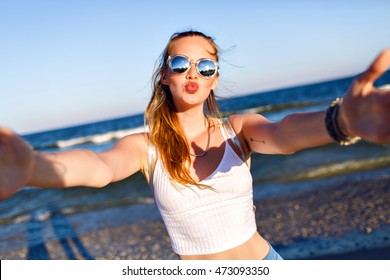 Cute Blonde Woman Making Selfie Near Ocean, Having Fun And Sending Air Kiss , Travel Alone, Tropical Luxury Beach Vacation, Sunglasses, Backpack, Pretty Face.