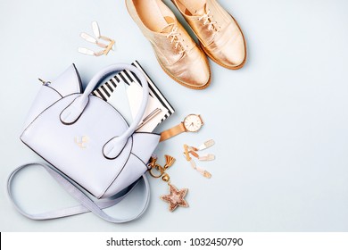 Cute blue ladies bag, stylish golden shoes and  feminine accessories . Flat lay, top view. Spring fashion concept in pastel colored  - Shutterstock ID 1032450790