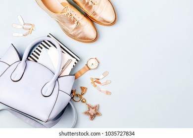Cute blue ladies bag, stylish golden shoes and  feminine accessories . Flat lay, top view. Spring fashion concept in pastel colored  - Shutterstock ID 1035727834