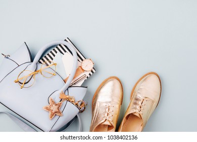 Cute blue ladies bag, stylish golden shoes and  feminine accessories . Flat lay, top view. Spring fashion concept in pastel colored  - Shutterstock ID 1038402136