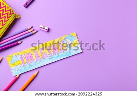 Cute bookmark with pencils on color background
