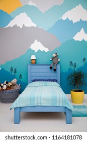 Cute boy bedroom design with a turquoise grey mountain wall mural. - Shutterstock ID 1164181078
