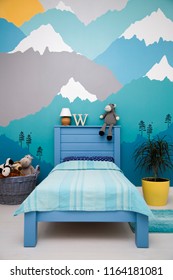 Cute boy bedroom design with a turquoise grey mountain wall mural - Shutterstock ID 1164181081