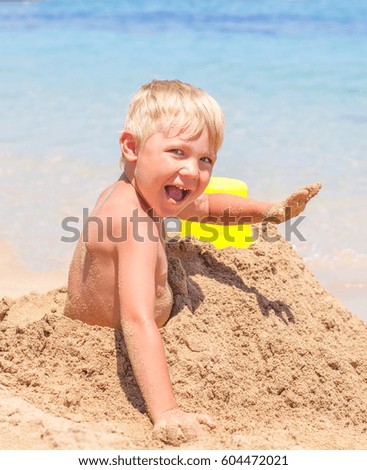 Similar – Image, Stock Photo Small child buried in the sand of the beach