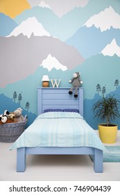 Cute boy child bedroom design with a turquoise grey mountain wall mural, see more of brighter photos on my portfolio  - Shutterstock ID 746904439