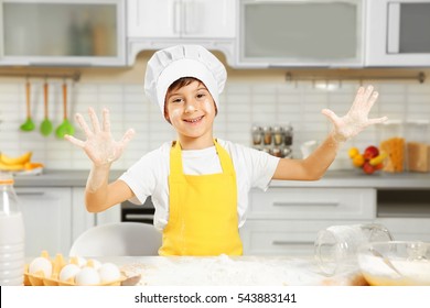 Cute Boy Cooking In Kitchen At Home