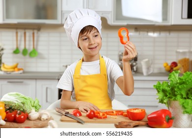 Cute Boy Cooking In Kitchen At Home