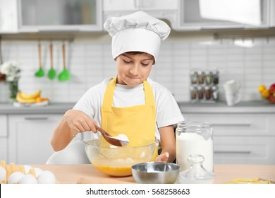 Cute Boy Cooking In Kitchen At Home