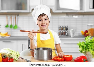 Cute Boy Cooking In Kitchen At Home