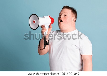Cute boy with down syndrome using a megaphone to amplify his voice. Teenage boy with down syndrome using a megaphone. Diverse activist protesting with megaphone for inclusivity and equality.