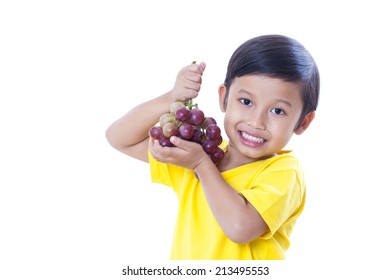 Cute Boy Eating Grapes Isolated On White 