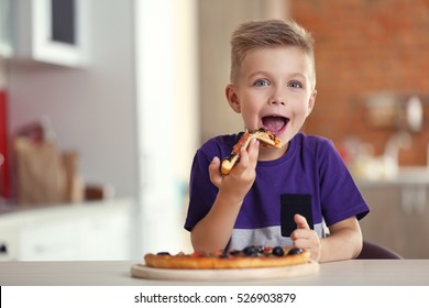 Cute Boy Eating Pizza At Home