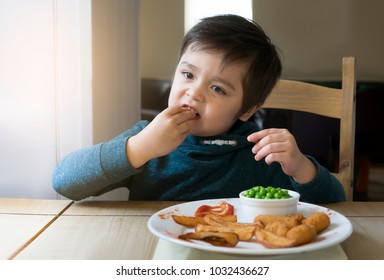 Cute Boy Enjoy Eating Scampi Chips Potato And Peas For His Sunday Lunch, Healthy Food For Children Concept 